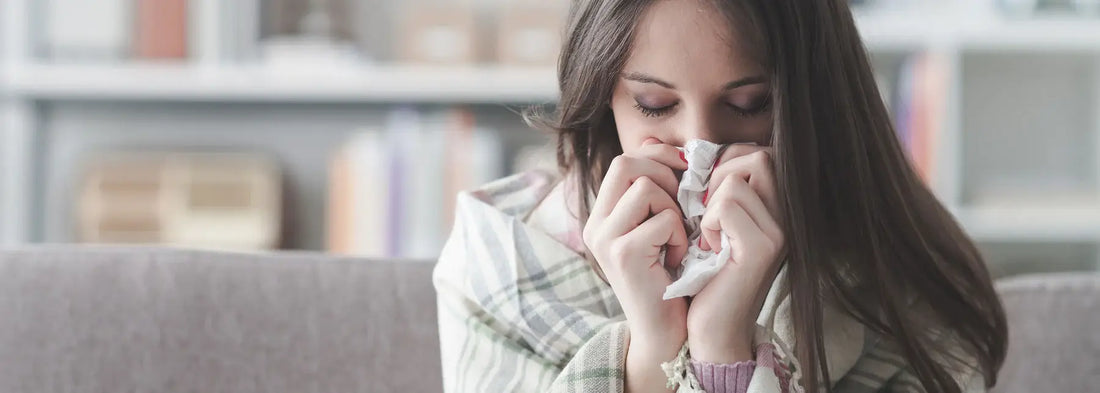 Image of a woman blowing her nose